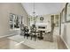 Dining room featuring a vaulted ceiling, large windows, chandelier, and fireplace at 7818 S Zeno St, Centennial, CO 80016