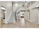 Bright entryway featuring hardwood floors, staircase with iron railing, and an arched mirror at 7818 S Zeno St, Centennial, CO 80016