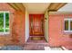 Beautiful brick home exterior with a classic wooden front door at 7818 S Zeno St, Centennial, CO 80016