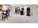 Basement game room with classic arcade games and cozy bar seating at 7818 S Zeno St, Centennial, CO 80016