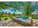 Backyard hot tub surrounded by trees and lush landscaping at 7818 S Zeno St, Centennial, CO 80016
