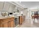 Kitchen island featuring wine fridge and granite countertops, adjacent to the dining area at 7818 S Zeno St, Centennial, CO 80016