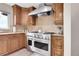 Gourmet kitchen featuring a professional-grade stove and custom cabinetry at 7818 S Zeno St, Centennial, CO 80016