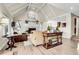 Comfortable living room featuring a fireplace, vaulted ceiling, and wood floors at 7818 S Zeno St, Centennial, CO 80016