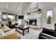 Cozy living room with a fireplace, vaulted ceilings, and comfortable seating at 7818 S Zeno St, Centennial, CO 80016