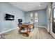 Home office featuring a large ornate desk, hardwood floors, and a door to the outside at 7818 S Zeno St, Centennial, CO 80016