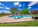 Outdoor pool with a slide, water features, lounge seating, and a lush lawn at 7818 S Zeno St, Centennial, CO 80016