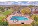 Aerial view of a large backyard pool area with a diving board, slide, lounge chairs, and landscaped surroundings at 7818 S Zeno St, Centennial, CO 80016