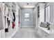 Walk-in closet featuring custom shelving, ample storage space, carpet, and a bright window at 7818 S Zeno St, Centennial, CO 80016