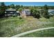 Backyard view from above showing a multi-level deck surrounded by grass and foliage at 984 Shadow Mountain Dr, Highlands Ranch, CO 80126