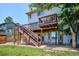 Multi-level deck with stairs, ideal for outdoor entertaining and relaxation in a grassy backyard at 984 Shadow Mountain Dr, Highlands Ranch, CO 80126