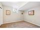 A carpeted room featuring two framed maps, natural light, and neutral walls at 984 Shadow Mountain Dr, Highlands Ranch, CO 80126
