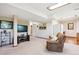 Finished basement area with a brown couch, TV, and a kitchenette at 984 Shadow Mountain Dr, Highlands Ranch, CO 80126