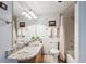 Bathroom with a granite countertop vanity, framed mirrors and a shower with curtain at 984 Shadow Mountain Dr, Highlands Ranch, CO 80126