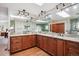 Bright bathroom features double vanity with granite counters, wood cabinets, and wood floors at 984 Shadow Mountain Dr, Highlands Ranch, CO 80126