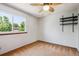 Cozy bedroom with neutral walls, ceiling fan, and bright window offering scenic views at 984 Shadow Mountain Dr, Highlands Ranch, CO 80126