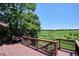 Inviting wooden deck showcases lovely views of lush green space and blue skies at 984 Shadow Mountain Dr, Highlands Ranch, CO 80126
