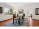 Bright dining room featuring hardwood floors, area rug, and a large window with natural light at 984 Shadow Mountain Dr, Highlands Ranch, CO 80126