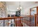 Open foyer features hardwood floors, stone accent wall, and lovely staircase with iron railings at 984 Shadow Mountain Dr, Highlands Ranch, CO 80126