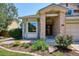 Charming home exterior featuring a brick entrance, mature landscaping, and a well-maintained lawn at 984 Shadow Mountain Dr, Highlands Ranch, CO 80126