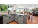 Kitchen featuring ample counterspace, gray cabinets, views, and hardwood flooring at 984 Shadow Mountain Dr, Highlands Ranch, CO 80126