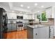 Modern kitchen with stainless steel appliances, island, granite countertops, and white and gray cabinets at 984 Shadow Mountain Dr, Highlands Ranch, CO 80126