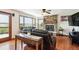 The living room features a stone fireplace, natural light, and deck access at 984 Shadow Mountain Dr, Highlands Ranch, CO 80126