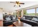 Open-concept living room with two couches, coffee table, and a connected kitchen with modern appliances at 984 Shadow Mountain Dr, Highlands Ranch, CO 80126