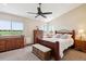 Sunlit main bedroom offers scenic views and classic wooden furniture at 984 Shadow Mountain Dr, Highlands Ranch, CO 80126