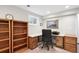 Home office in basement featuring built in desk and shelves. Natural light at 984 Shadow Mountain Dr, Highlands Ranch, CO 80126