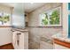Updated shower features sleek glass doors, neutral tile, and a built-in bench at 984 Shadow Mountain Dr, Highlands Ranch, CO 80126