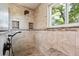 Modern shower with rain shower head, pebble floor, and built-in shower niche at 984 Shadow Mountain Dr, Highlands Ranch, CO 80126