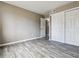 An empty bedroom with a closet and grey wood-look floors at 1777 S Pitkin St # A, Aurora, CO 80017