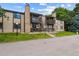 Beautiful tan townhouse complex with stone accents, a grassy lawn, and stairway to the units at 1777 S Pitkin St # A, Aurora, CO 80017