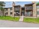 Beautiful tan townhouse complex with stone accents, a grassy lawn, and stairway to the units at 1777 S Pitkin St # A, Aurora, CO 80017