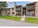 Charming condo exterior with stone accents, balconies, and well-maintained landscaping at 1777 S Pitkin St # A, Aurora, CO 80017