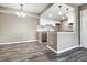 Kitchen featuring white cabinets, granite counters, stainless steel dishwasher, and pendant lighting at 1777 S Pitkin St # A, Aurora, CO 80017