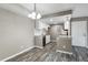 Open concept kitchen with granite countertops, stainless steel appliances, and modern pendant lights at 1777 S Pitkin St # A, Aurora, CO 80017