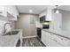 Close-up of the kitchen featuring stainless steel appliances, granite counters, and white cabinetry at 1777 S Pitkin St # A, Aurora, CO 80017