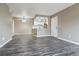 Well-lit living room and kitchen area with an open floor plan and modern light fixtures at 1777 S Pitkin St # A, Aurora, CO 80017