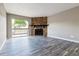 Inviting living room with stone fireplace, sliding glass door, and modern gray floors at 1777 S Pitkin St # A, Aurora, CO 80017