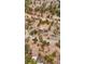 Sweeping aerial view of a blue home with an attached two car garage surrounded by trees at 248 Copperdale Ln, Golden, CO 80403