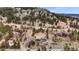 An aerial view of a mountain home with a two-car garage and curved driveway at 248 Copperdale Ln, Golden, CO 80403