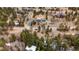 Sweeping aerial view of a blue home with an attached two car garage surrounded by trees at 248 Copperdale Ln, Golden, CO 80403