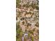 Sweeping aerial view of a blue home with an attached two car garage surrounded by trees at 248 Copperdale Ln, Golden, CO 80403