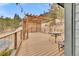 Wooden back deck features a pergola, metal railing and outdoor table and chairs at 248 Copperdale Ln, Golden, CO 80403