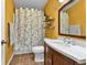 Bathroom featuring sink, toilet and shower with a leaf-patterned curtain at 248 Copperdale Ln, Golden, CO 80403