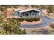 Exterior view of a home with a large deck, lush landscaping, and a paved driveway at 248 Copperdale Ln, Golden, CO 80403