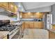 View of the kitchen showcasing tile floors, stainless steel appliances, and wooden cabinetry at 248 Copperdale Ln, Golden, CO 80403