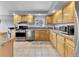 Well-lit kitchen with wooden cabinets, stainless steel appliances, and tiled backsplash at 248 Copperdale Ln, Golden, CO 80403